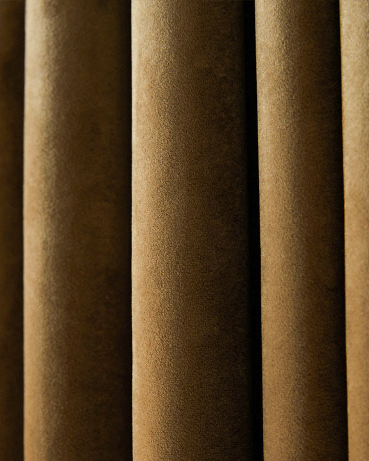 Close-up of Moonlit Velvet custom curtain fabric in deep brown with soft, plush texture and elegant vertical folds.