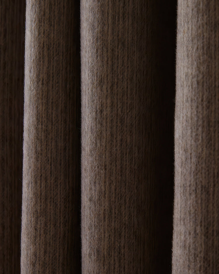 Close-up of custom Aspen Wool Blend Sweater textured curtain fabric in a rich cocoa brown, highlighting its soft, luxurious drape.