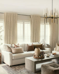 Floor-to-ceiling custom Nara linen & cotton blend lightweight drapery in a sunlit living room with white shutters and neutral decor.