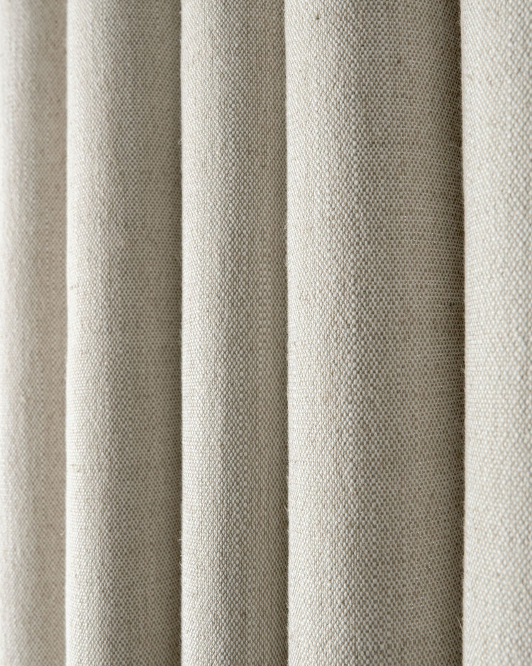 Detailed view of a Sally Linen Blend custom curtain, highlighting its natural woven texture and light beige color.