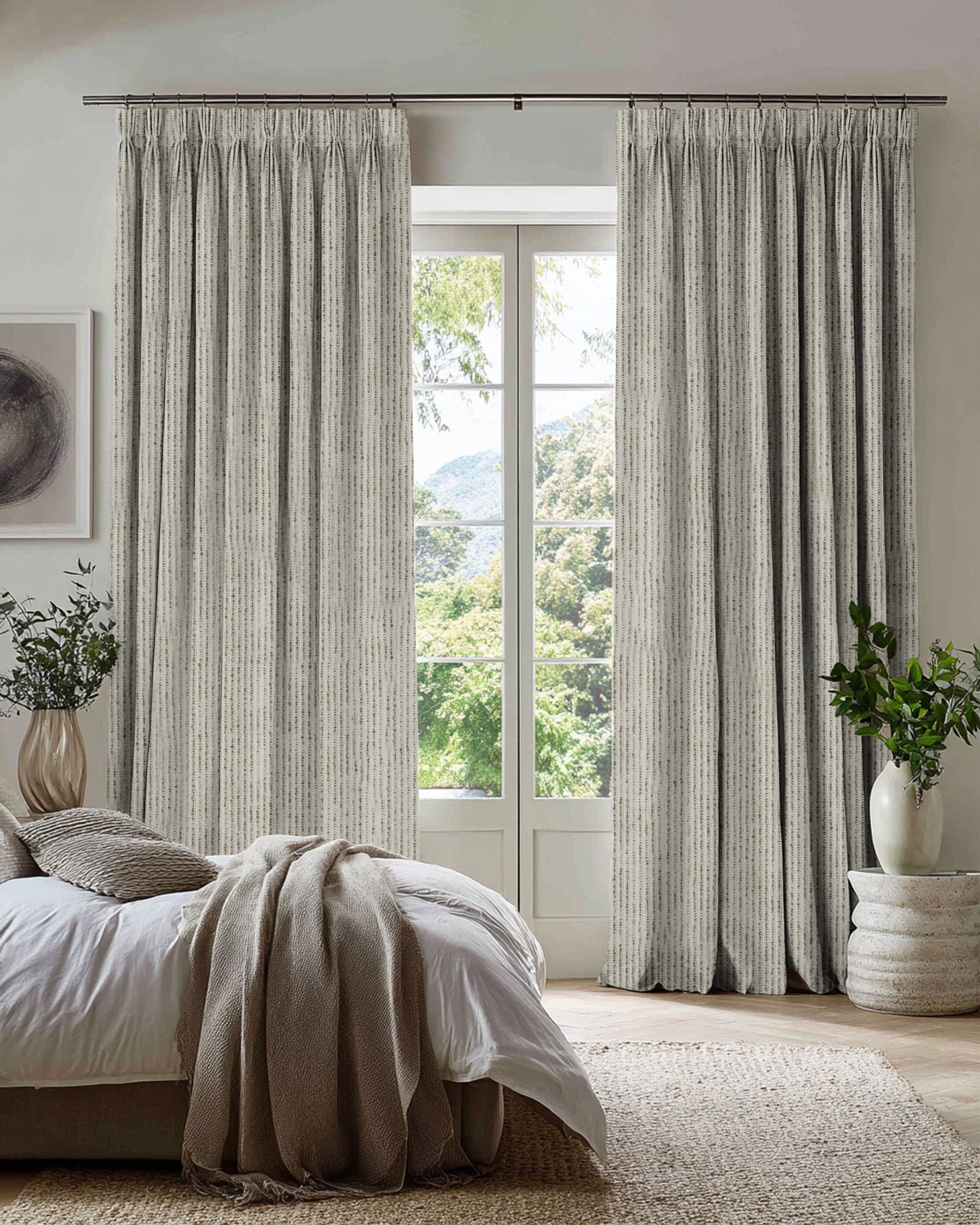 Full-length Liwa Linen Blend custom pleated curtains with subtle desert-toned dotted jacquard pattern in a bright bedroom.