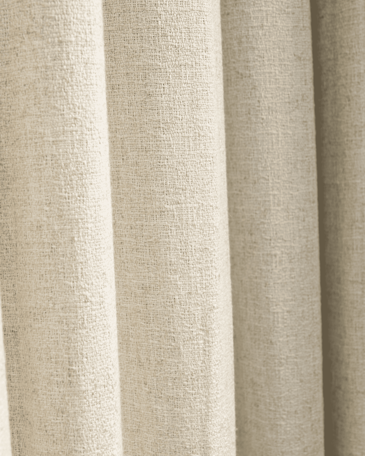 Close-up of the Fiona linen blend custom curtain fabric, showcasing its natural textured weave and elegant, soft drape.