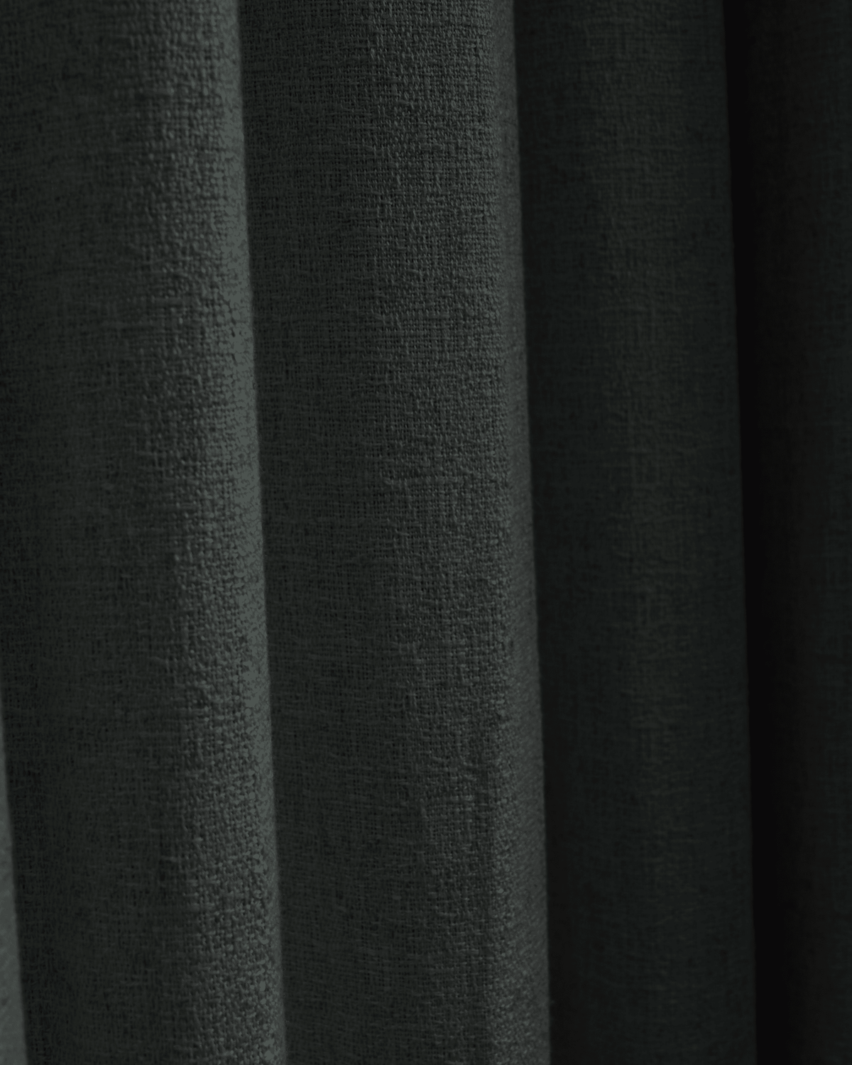 Close-up of dark grey Fiona linen blend custom curtain fabric, showing natural woven texture and elegant drapery folds.