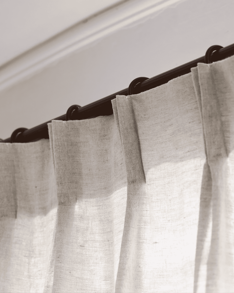 Tahiti 100% pure linen custom drapery with tailored pinch pleats on a dark brown curtain rod.