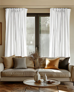 White Laborien linen-look custom blackout curtains with pinch pleat header on a window, offering thermal & soundproof light control.