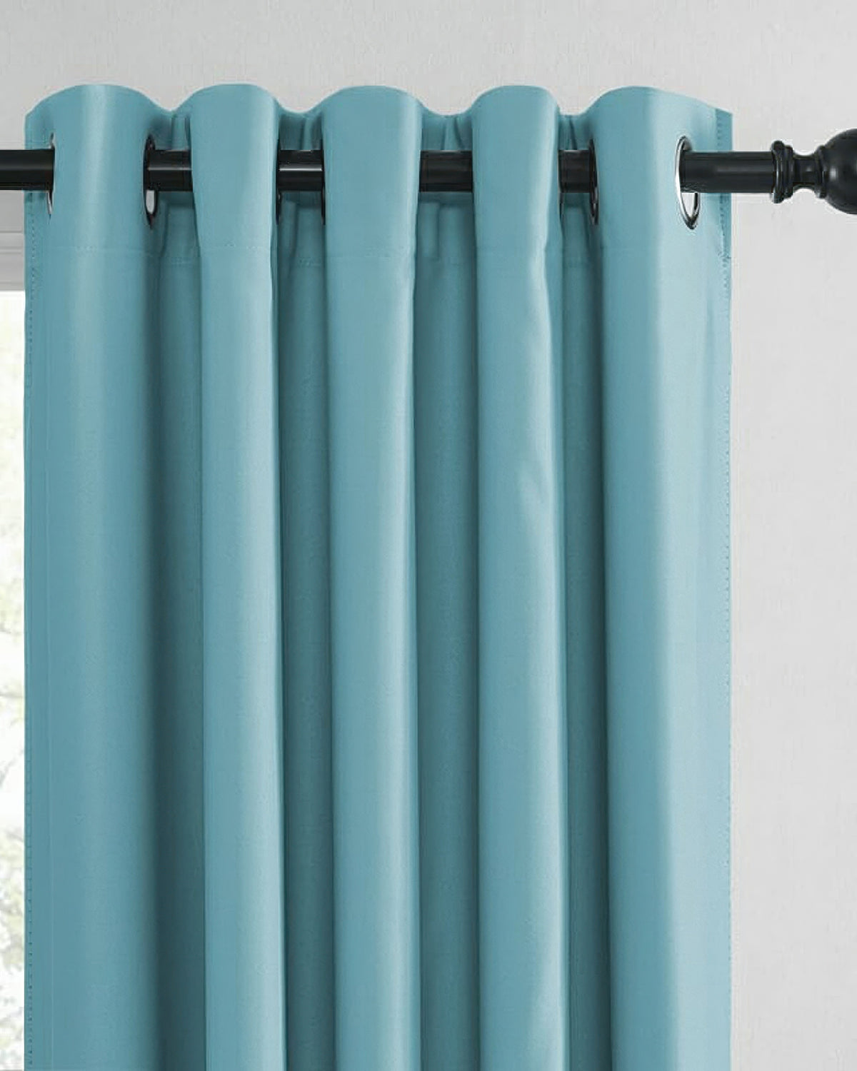 Close-up of a vibrant teal custom grommet curtain panel with elegant folds, emphasizing tailored light control and modern home decor.
