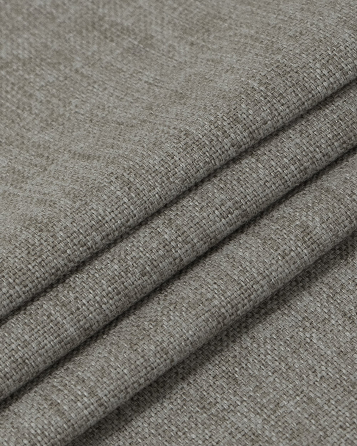 Heavyweight greige blackout custom curtain fabric with a refined linen look texture and elegant folds.