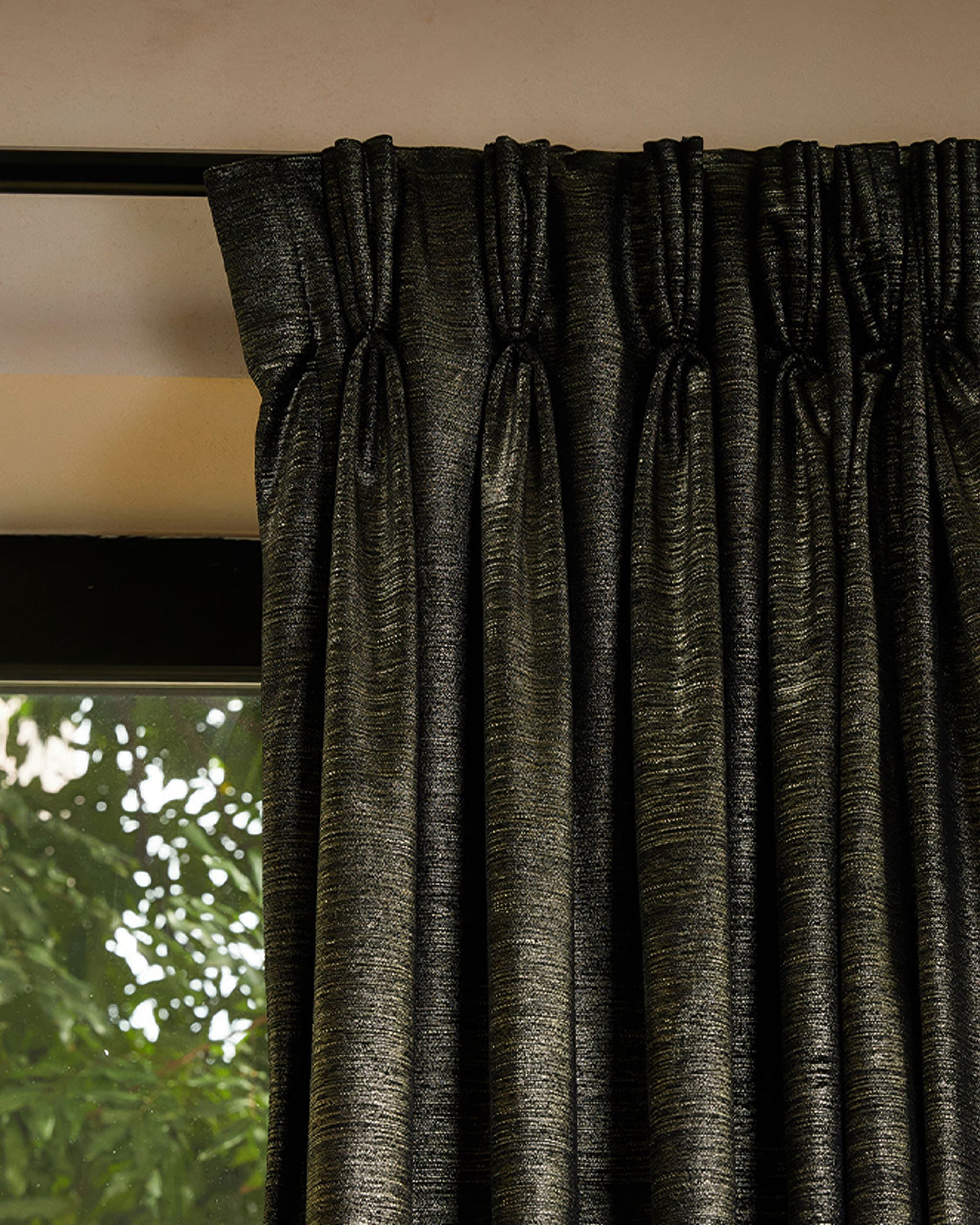 Dark custom velvet drapery with Rome foil print, featuring tailored pleats & luxurious texture, perfect for home aesthetics.