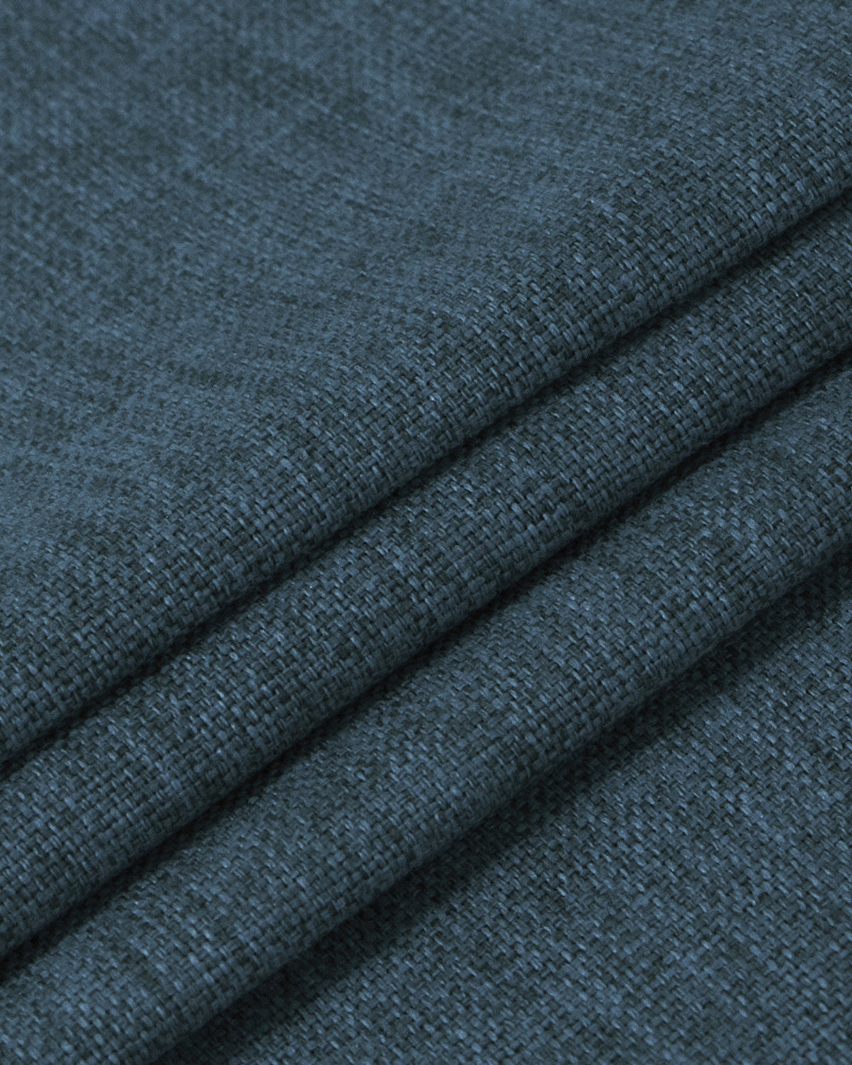 Close-up of deep slate blue heavyweight linen custom curtain fabric, showing dense woven texture and soft folds for 100% blackout.