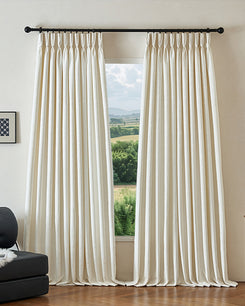 Cream custom blackout curtains with pinch pleat header. Ambient thermal, soundproof jacquard linen blend fabric. Scenic window view.