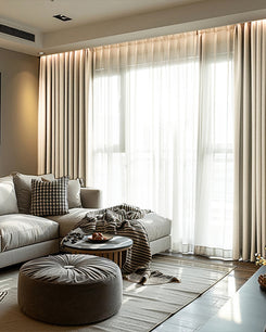 Modern living room features Cronin Linen Look Blackout Custom Curtains paired with sheers, creating tailored privacy & light control.