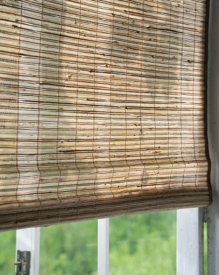 Ecru Mia Jute Woven Shade, detailed view of natural fiber texture with sunlight filtering through, offering light control & privacy.