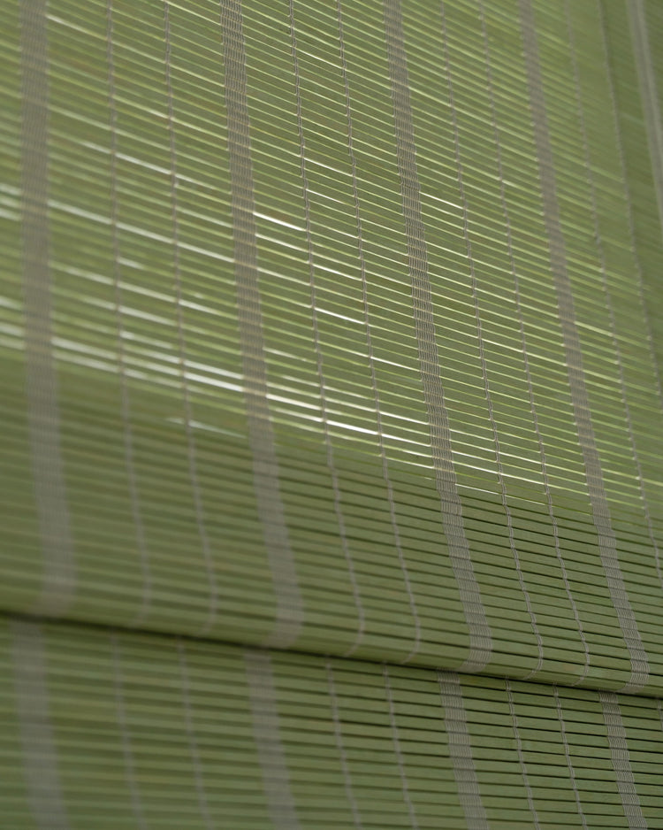 Close-up of Hana green bamboo woven shade, highlighting its natural texture and custom light filtering weave.