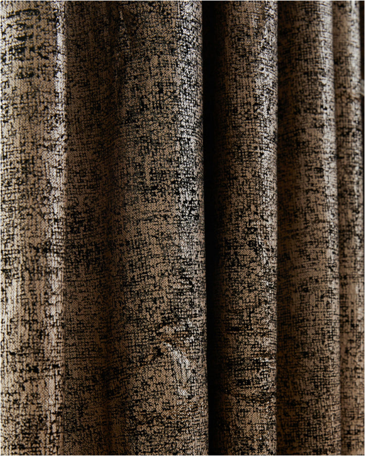 Draped Klimt foil printed luxury velvet custom curtain fabric, featuring a shimmering distressed black & golden abstract pattern.