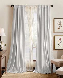 Custom light grey pleated blackout curtains over sheers, offering 100% blackout, soundproof, and thermal insulation for elegant home decor.