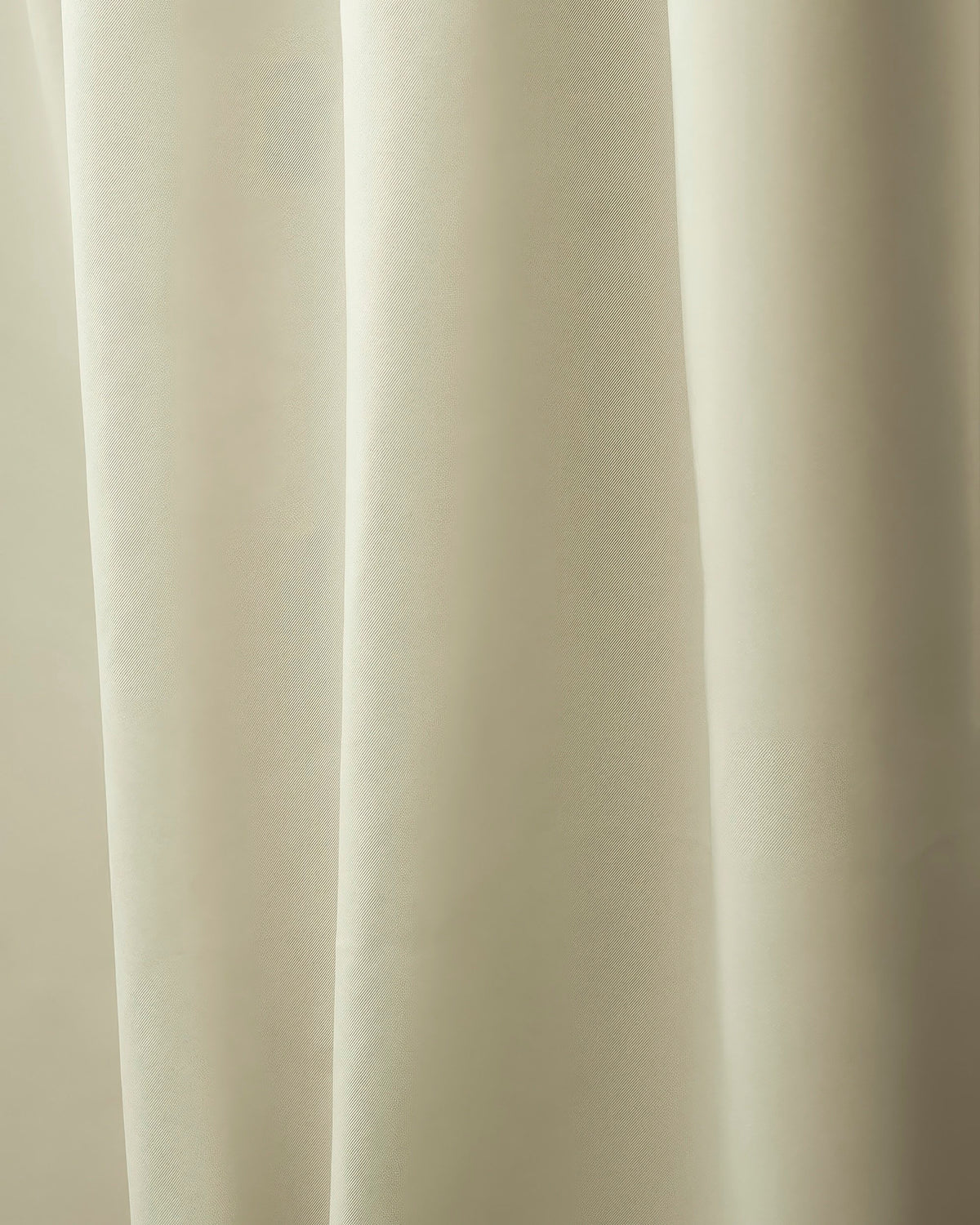 Detail of Hussein OEKO Certified custom curtain in light beige, showing the soft fabric texture and elegant vertical folds.