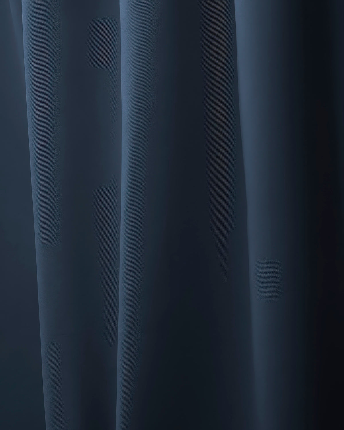 Hussein OEKO Certified custom dark blue drapery, revealing its subtle diagonal weave texture and soft, elegant folds.