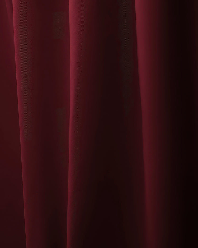 Deep burgundy custom curtain fabric with elegant folds, highlighting its premium OEKO certified luxury material.