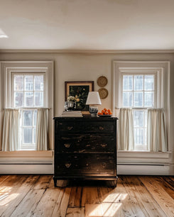Off-white Sally Linen Blend Custom Cafe Curtains on two windows, offering tailored privacy and soft light in a warm, sophisticated home.