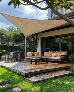 Beige UVShield waterproof custom triangle sun shade sail providing shade for an outdoor patio deck and lounge area.