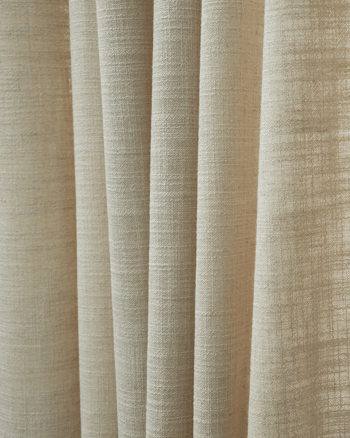 Close-up of natural beige Cassie linen blend drapery fabric, highlighting its textured weave for custom window treatments.