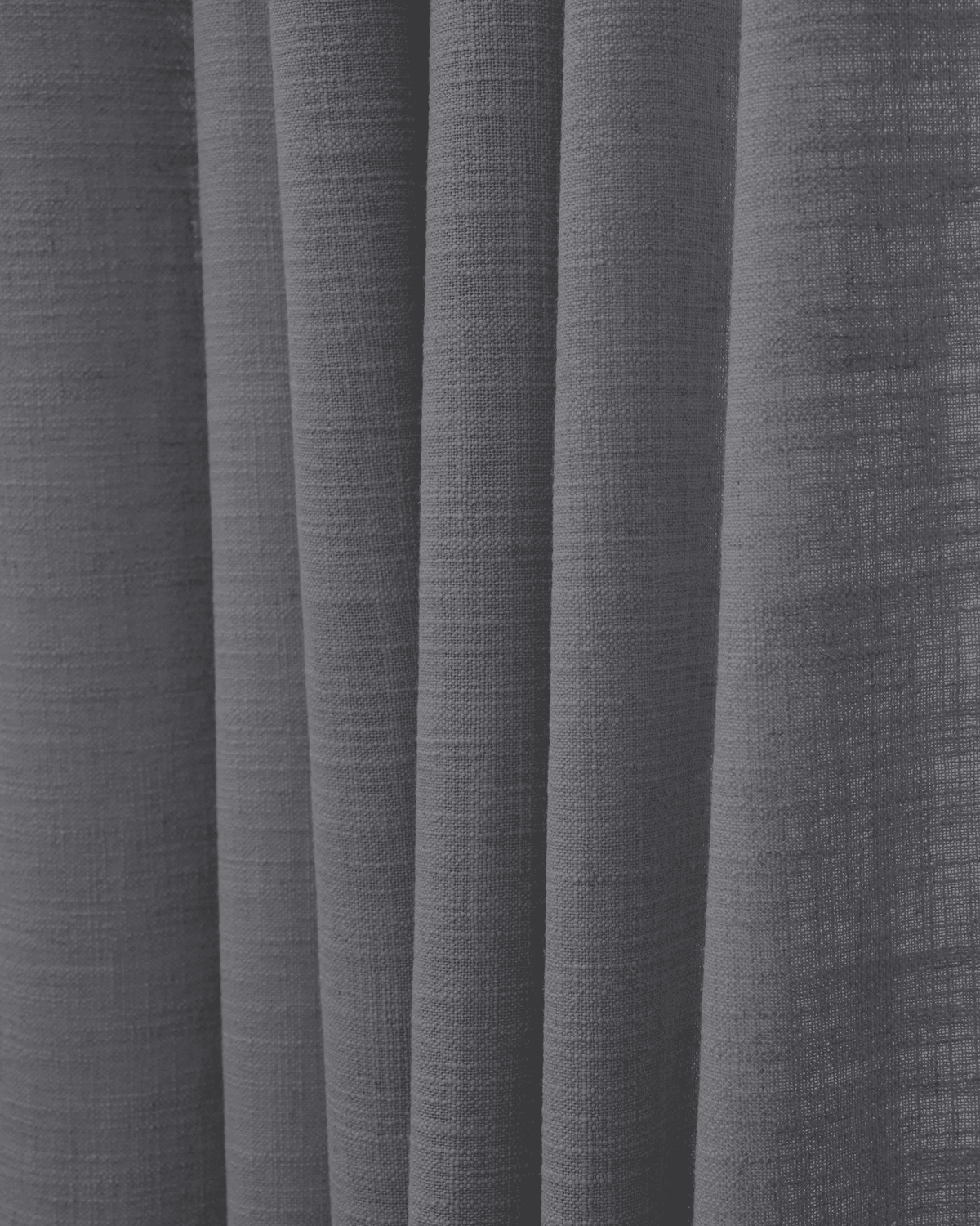 Close-up of deep charcoal Cassie linen blend fabric, showcasing its natural texture and soft folds for elegant custom drapery.