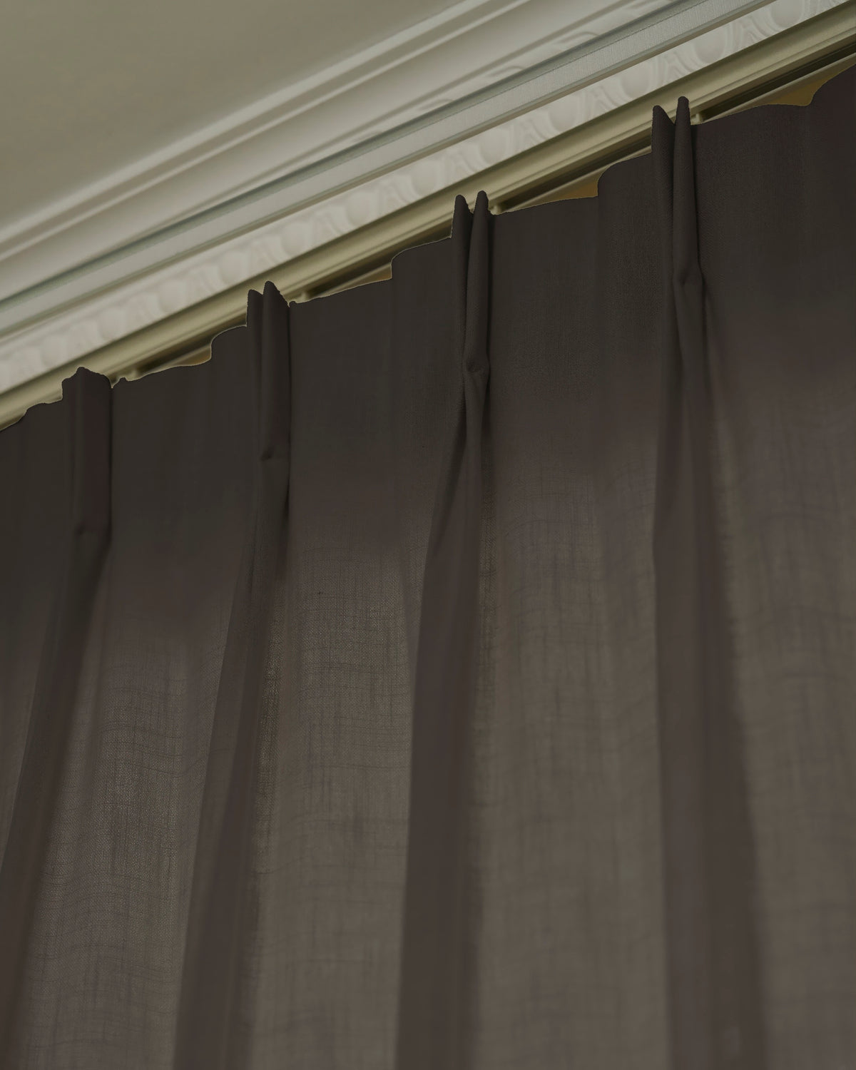 Detail of Cassie Linen Blend custom curtains in dark taupe, showing the tailored pinch pleat header style & rich fabric texture.