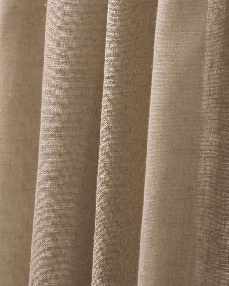 Close-up of premium blackout linen look burlap textured drapery fabric in a natural beige, showcasing its tight weave.