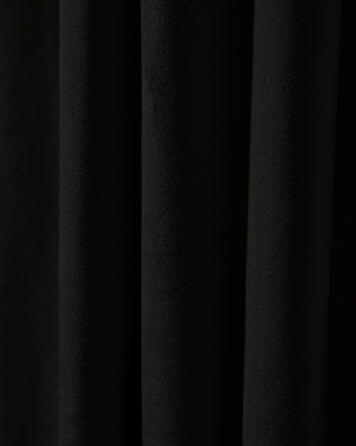 Deep black classic velvet fabric swatch with soft pile texture and elegant folds, perfect for custom window treatments.