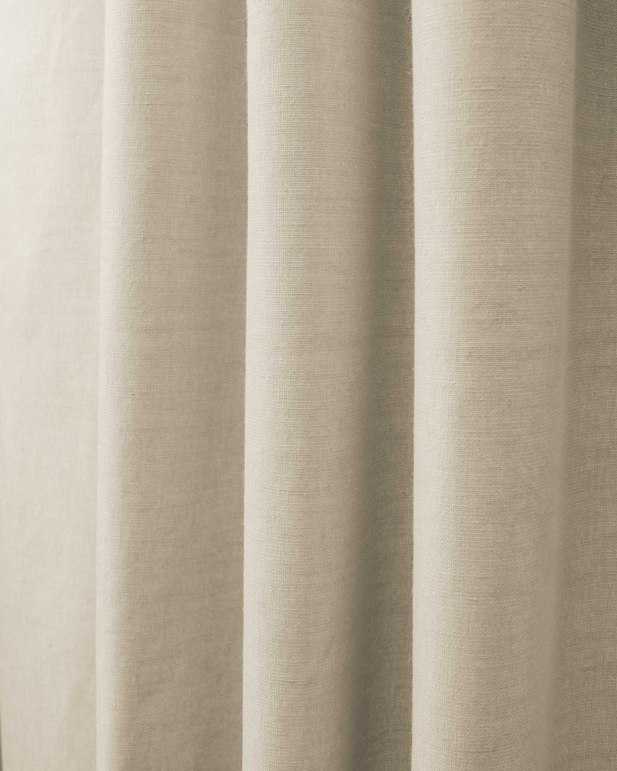 Detailed texture of Cronin natural linen-look blackout custom curtain fabric with soft, elegant folds.