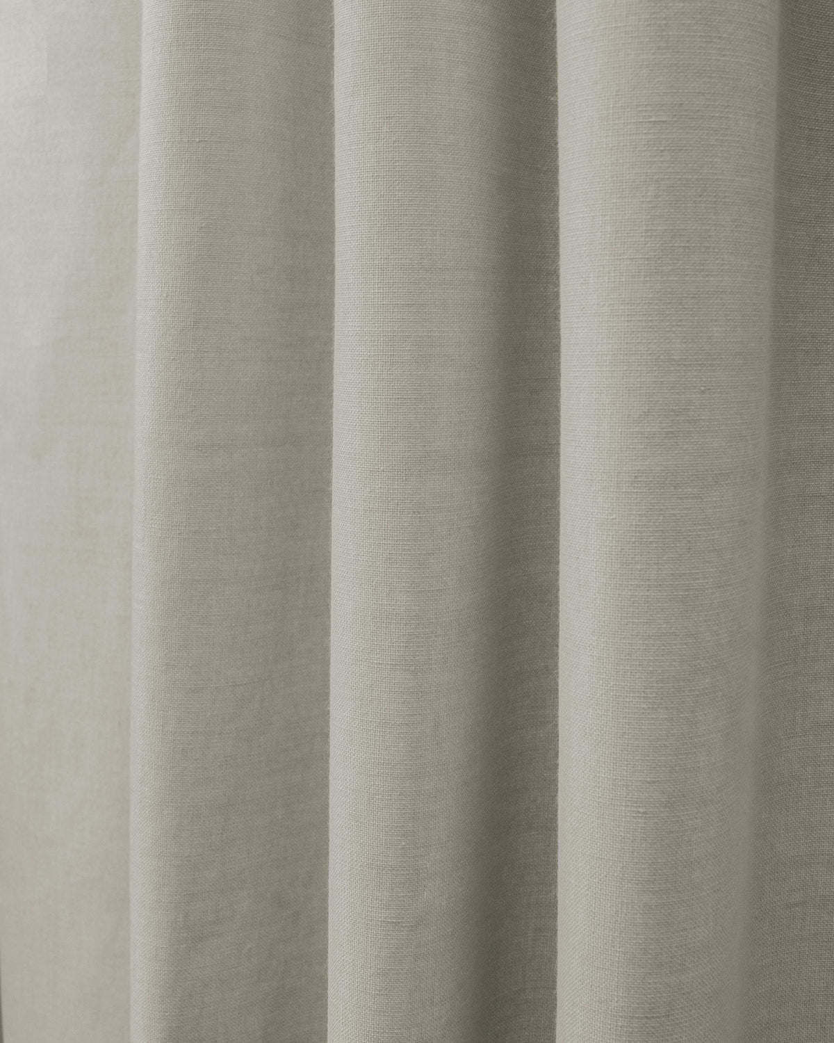 Close-up of Cronin Linen Look Blackout Custom Curtain fabric in a neutral shade, highlighting its textured weave and elegant folds.