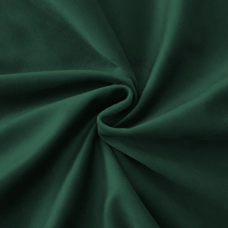 Close-up of deep forest green luxury velvet custom curtain fabric with soft folds showcasing rich texture for home decor.