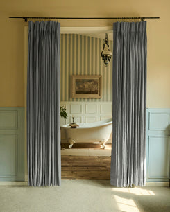 Elegant dark grey linen custom curtains with refined pinch pleats on a black rod, providing luxurious custom window treatments.
