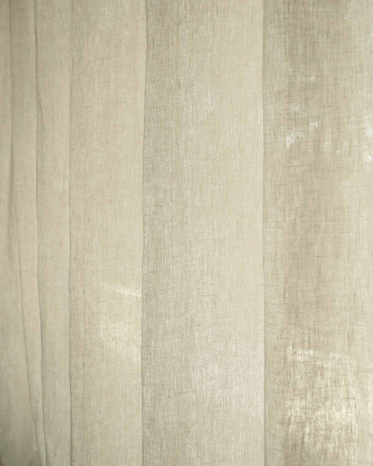 Close-up of Helena 100% pure linen custom curtains, showcasing the natural texture and elegant light filtering for a tailored look.