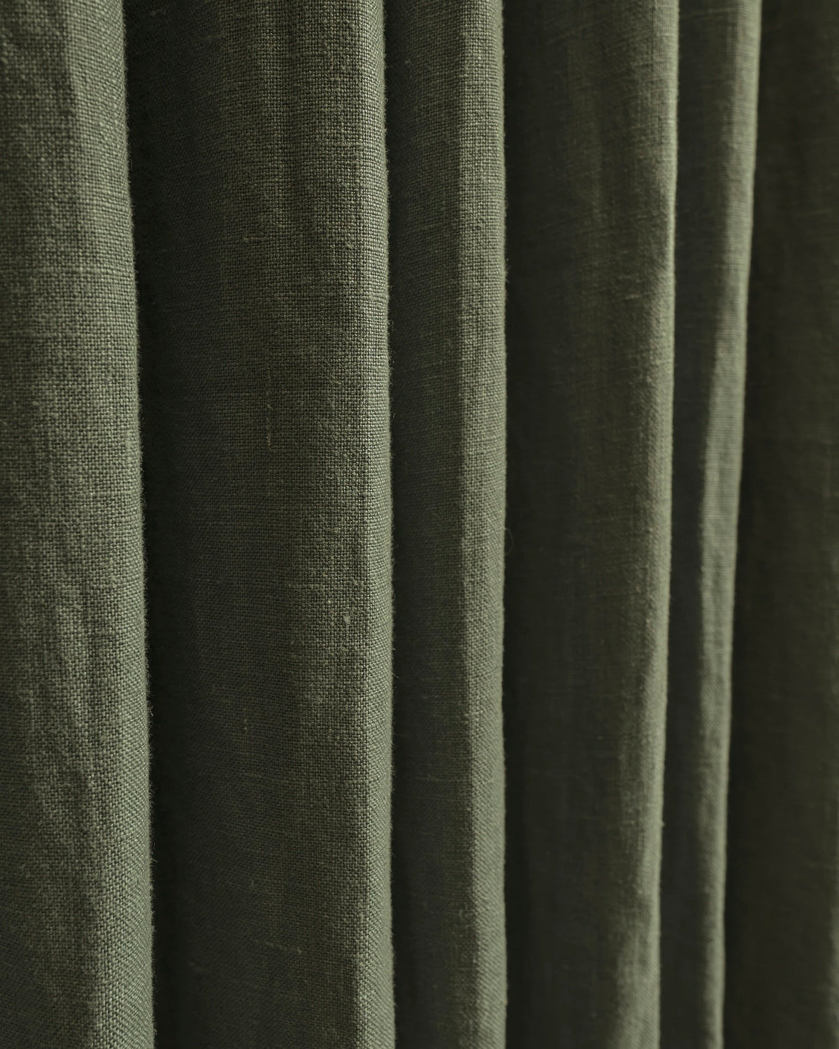 Helena 100% pure linen custom curtains in a dark green shade, showcasing the exquisite fabric texture and delicate pleats.