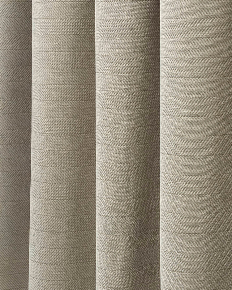 Detailed view of beige herringbone chenille fabric, highlighting its plush texture for custom 100% blackout curtains.