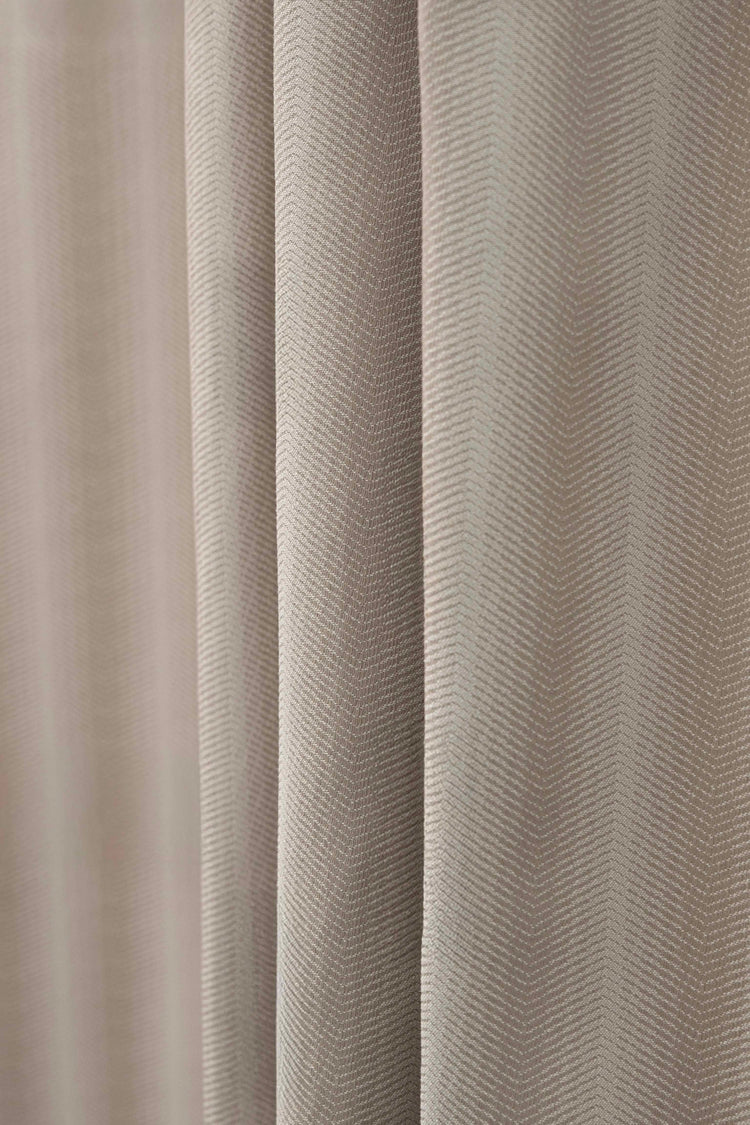 Close-up of TheHues Miami Fishtail patterned waterproof custom outdoor curtain fabric in neutral beige, showcasing its unique woven texture.