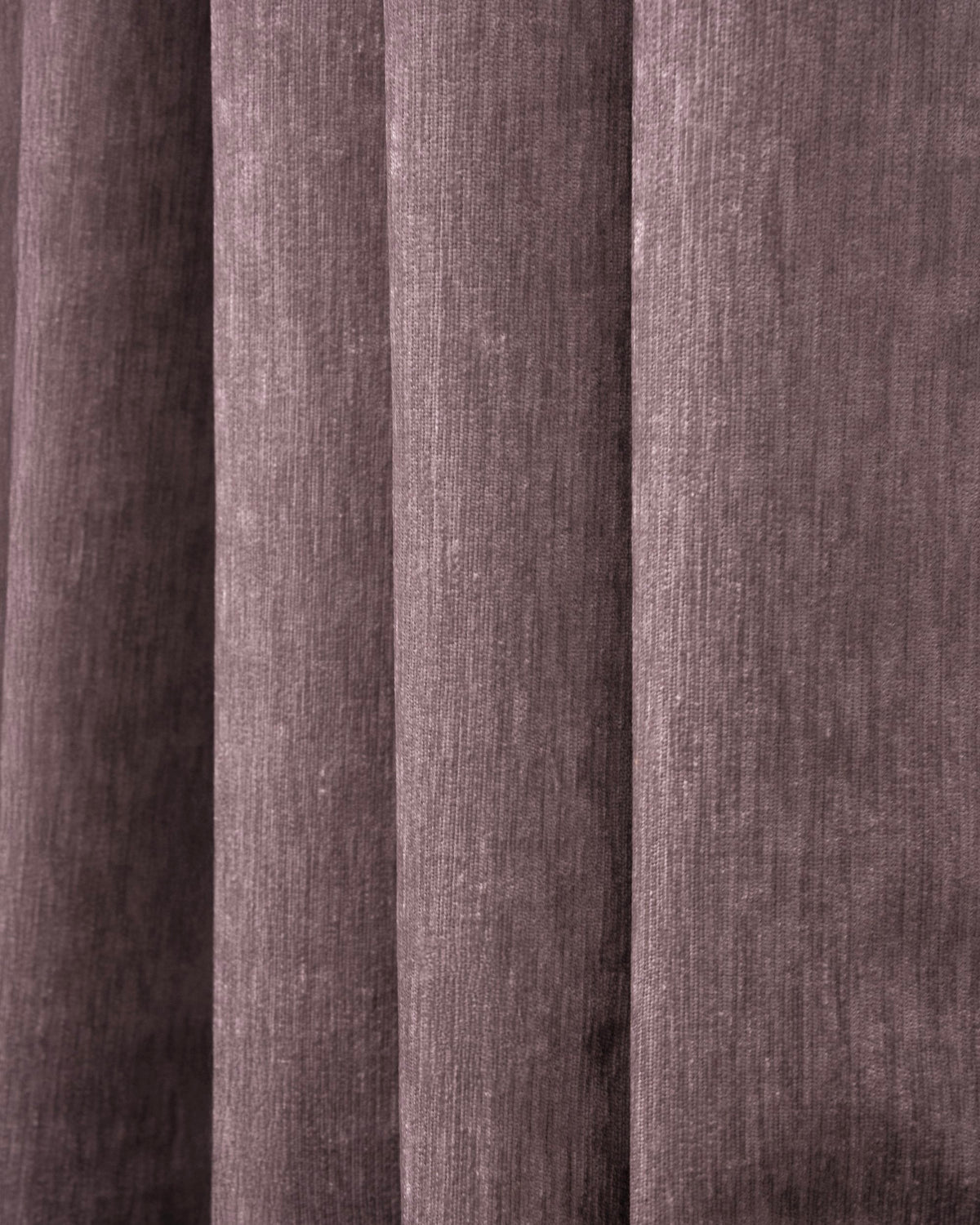 Close-up of deep plum heavyweight velvet custom blackout curtain fabric, showcasing its plush texture and elegant pleats.