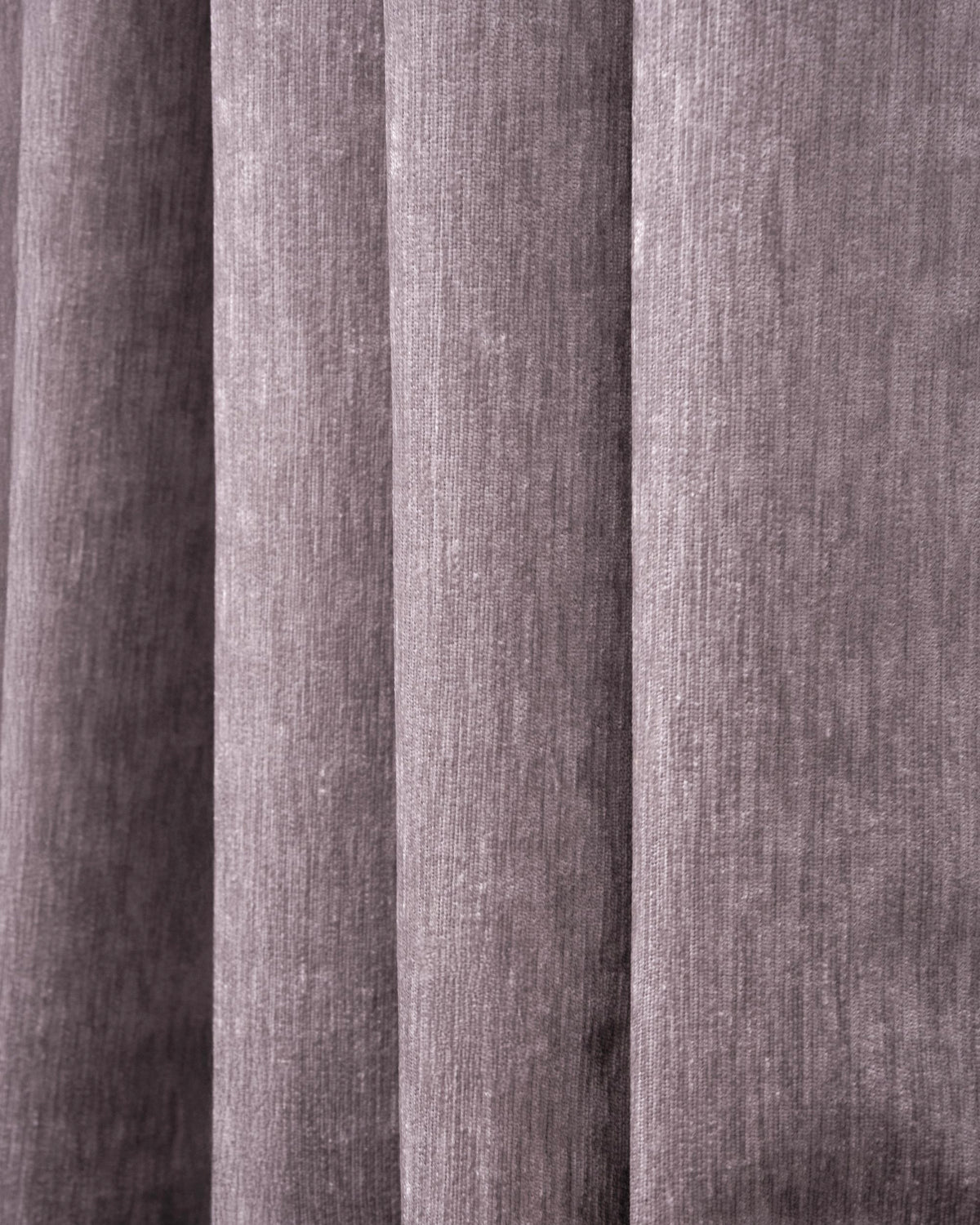Close-up of a pleated heavyweight blackout velvet custom curtain, highlighting the plush, dense fabric texture.