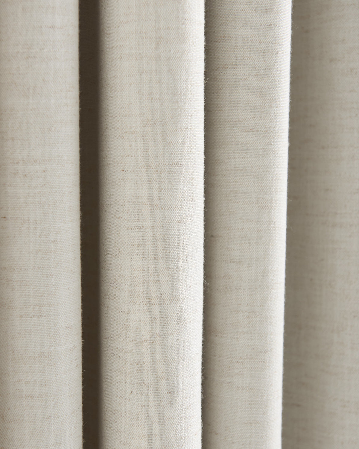 Detailed view of Sally Linen Blend fabric swatch in light beige, highlighting its natural slub texture and soft drapery folds.