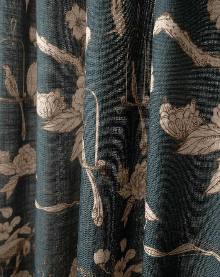 Close-up of teal blue Seeker Linen Blend Floral Patterned Fabric Swatches with vintage beige bird and floral motifs.