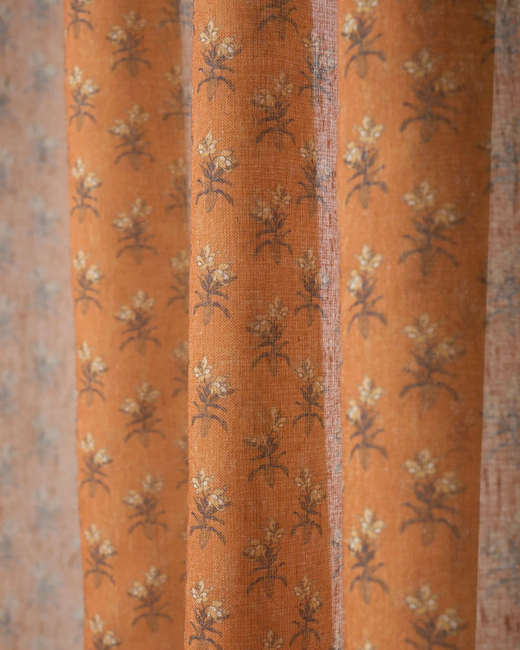 Burnt orange Rhythm Floral patterned sheer fabric swatch with a delicate floral print for custom window treatments.