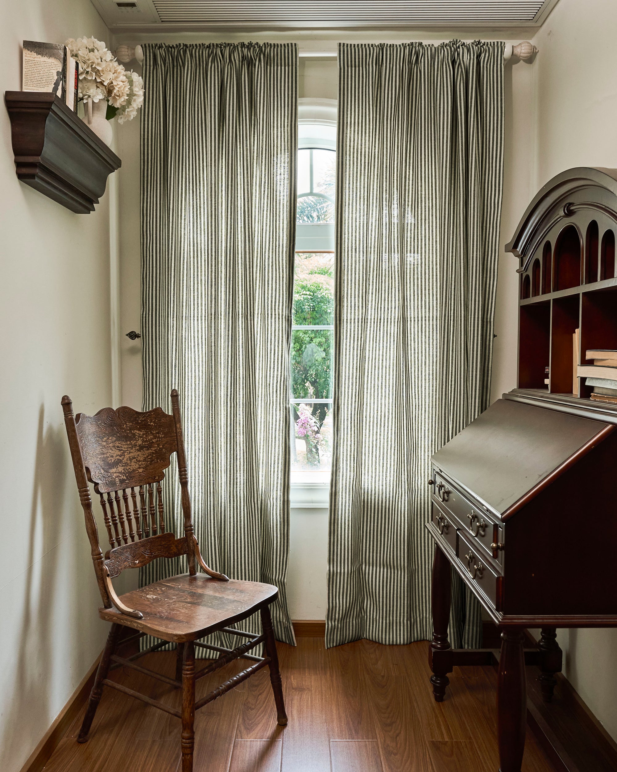 Custom striped Milo linen blend curtains with unfussy grace & grainy texture, perfectly tailored for light control in a serene room.