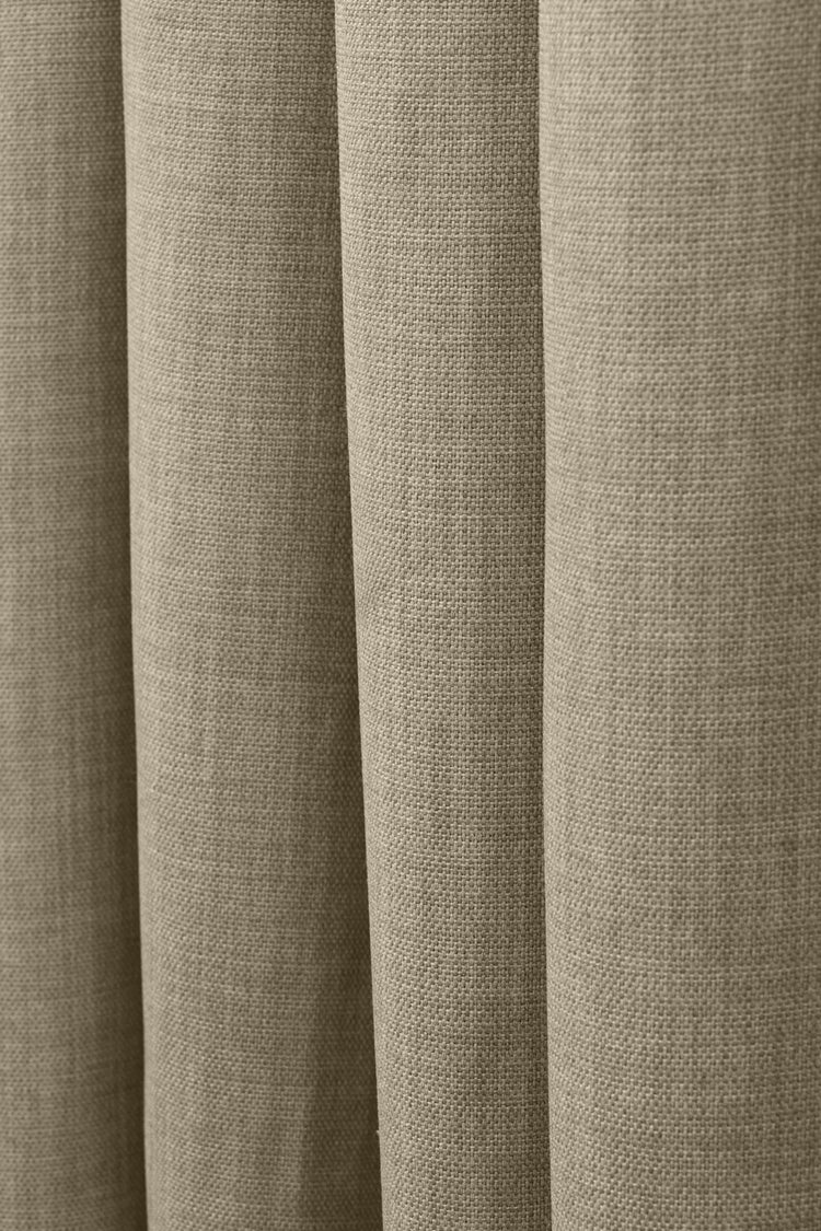 Detail of Zoe custom curtain, showcasing the soft, textured linen-look fabric in a natural taupe hue with elegant drapes.