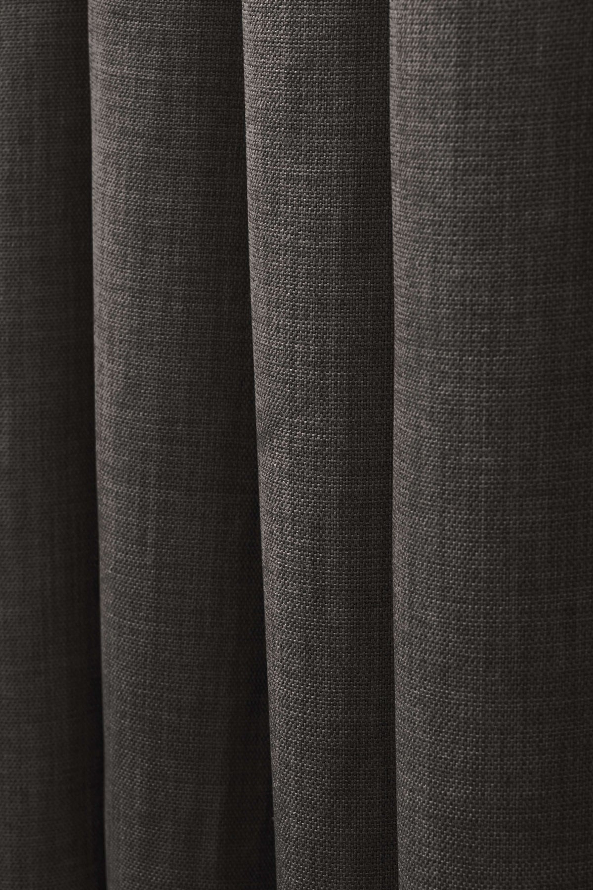 Close-up of dark grey Zoe linen look custom curtain fabric, with detailed woven texture and soft, elegant drapery folds.