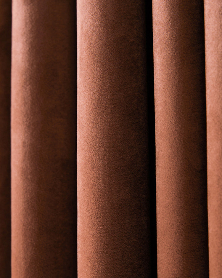 Rich brown velvet blackout curtain detail, showcasing plush fabric texture and soft folds for thermal & soundproof custom drapery.