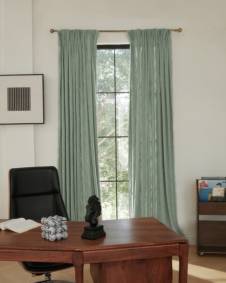 Sage Ivy Linen Look Heavyweight Herringbone custom curtains with gathered pleats, enhancing a bright home office window.