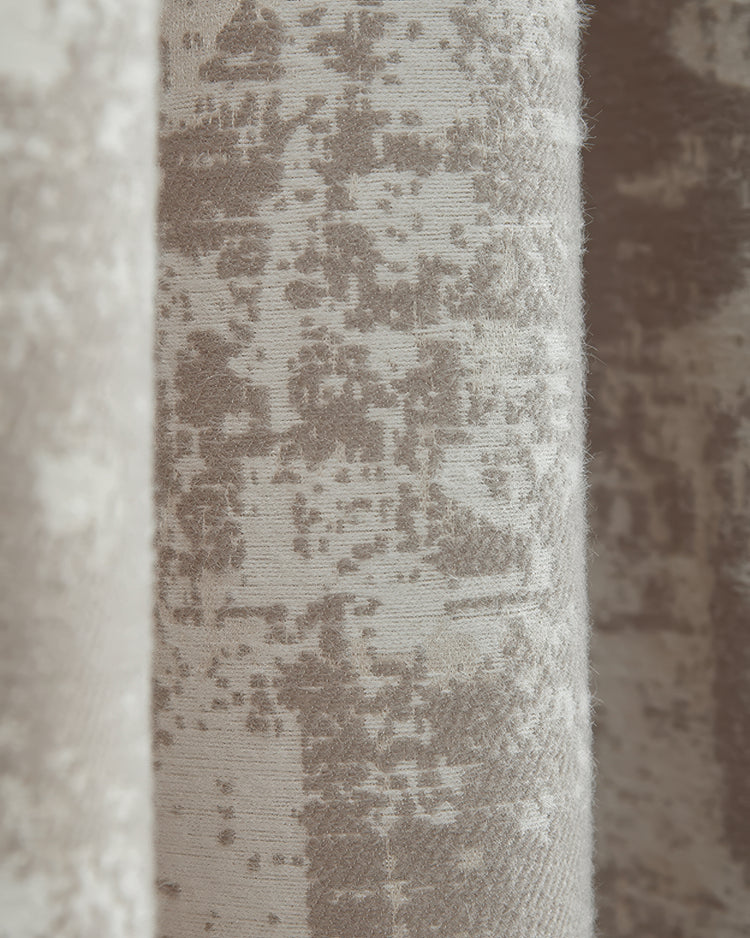 Close-up of Mist patterned heavyweight blackout curtain fabric, showing a textured grey-beige abstract design for home decor.