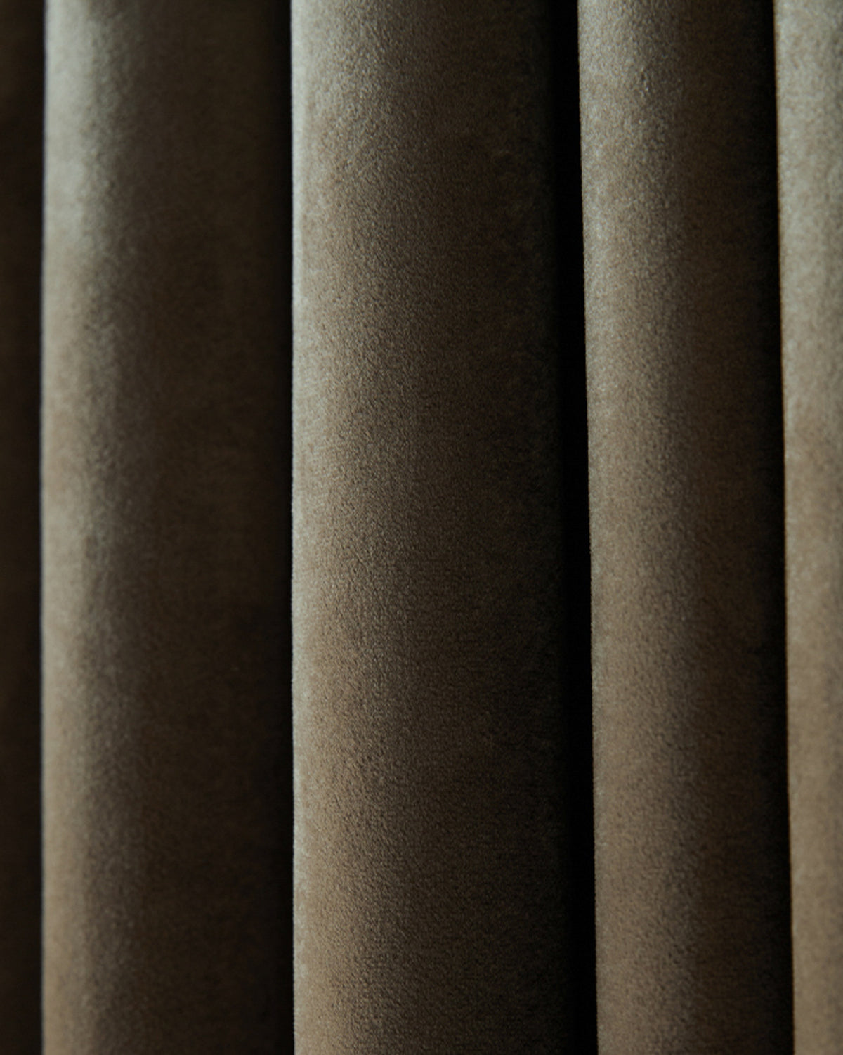 Deep taupe Moonlit Velvet custom drapery, highlighting its luxurious texture and soft, elegant folds.