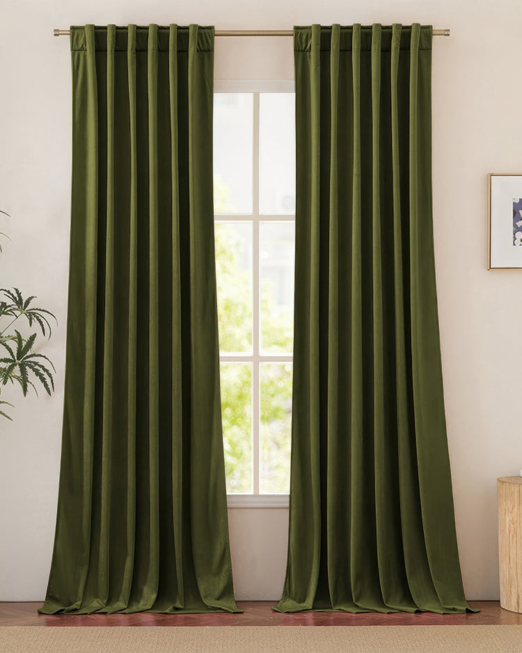 Heavyweight luxury dark green velvet custom drapery, tab top header, framing a sunlit window.